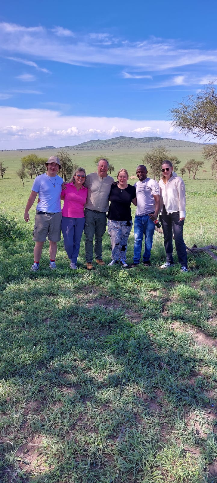 Reisegruppe vor der Landschaft am Kilimandscharo